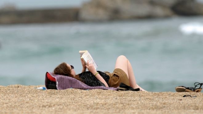 160801094415_reading_on_the_beach_2_640x360_afp_nocredit